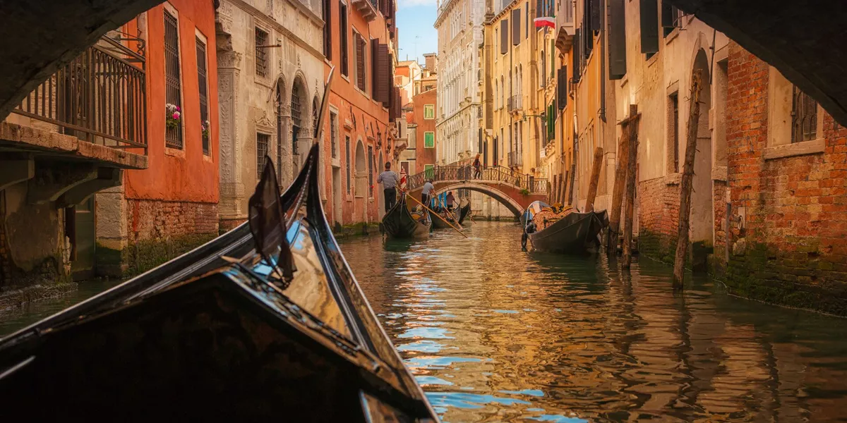 Gondola passing under a bridge in Venice, Italy