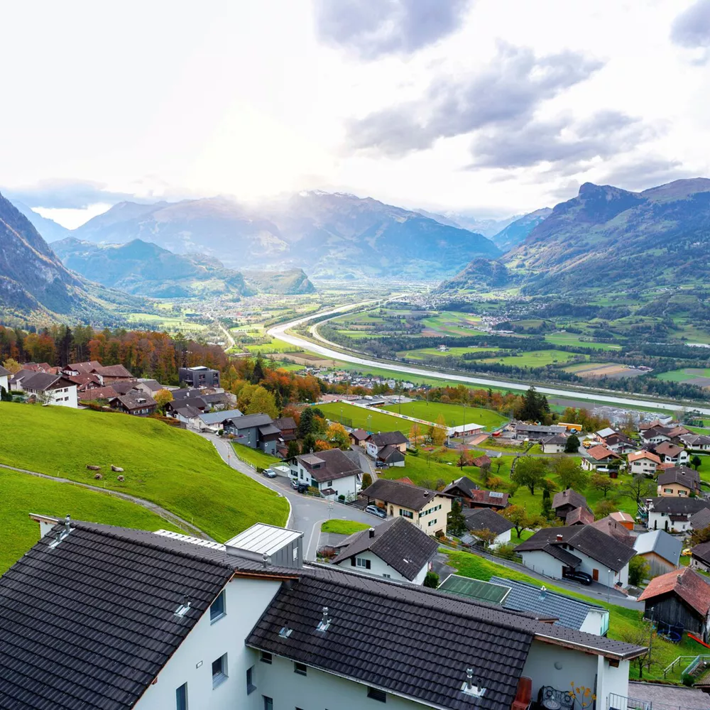 Scenic Aerial View Of Hillside Villages In Triesenberg And The River Rhine, Natural Border Of Liechtenstein, An Alpine Country In Central Europe