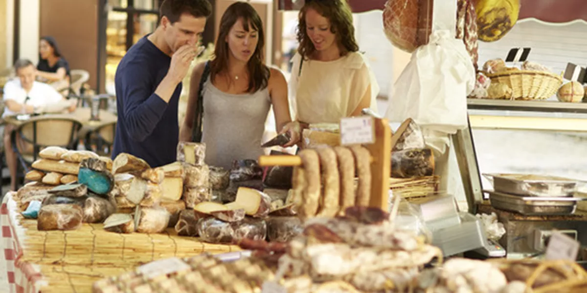 People tasting cheese at the market
