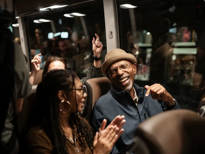 Man and woman sitting in a bus and laughing