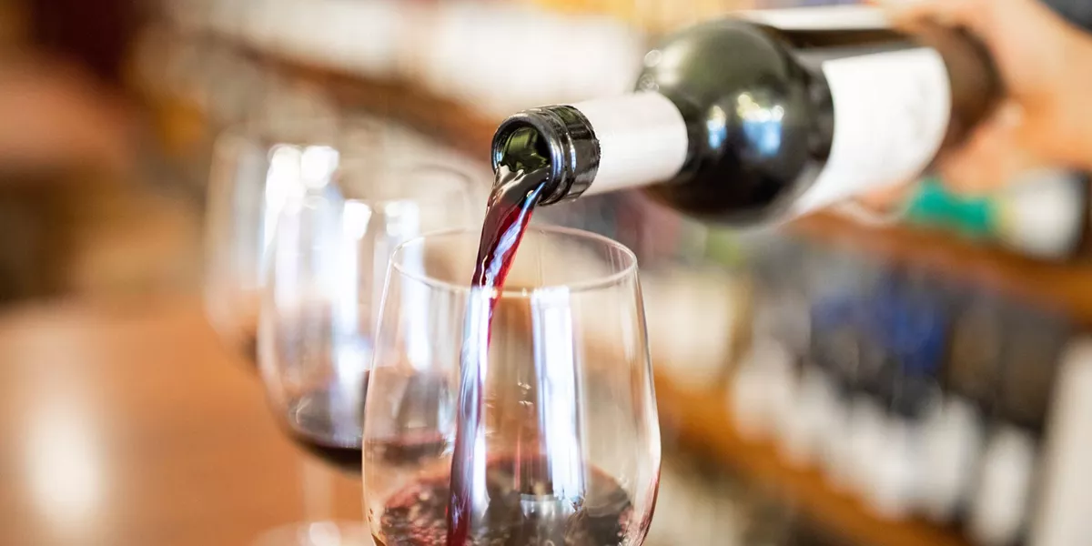 Bartender Pouring Wine Into Glasses