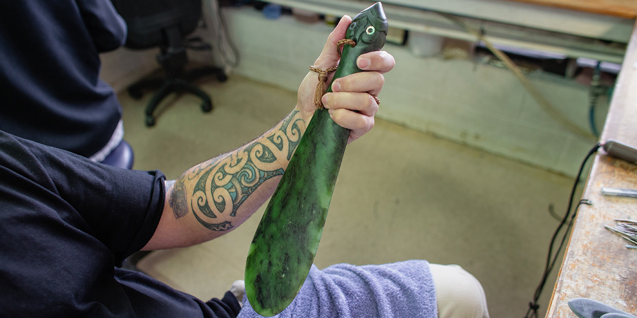 man-holding-jade-carving.jpg