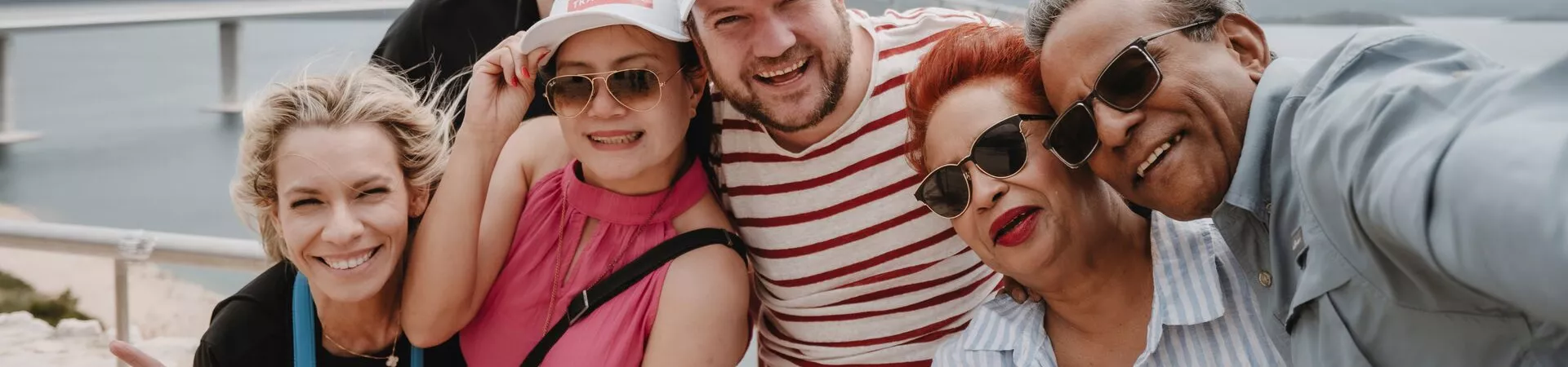 A group of guests pose by the seafront in the Balkans