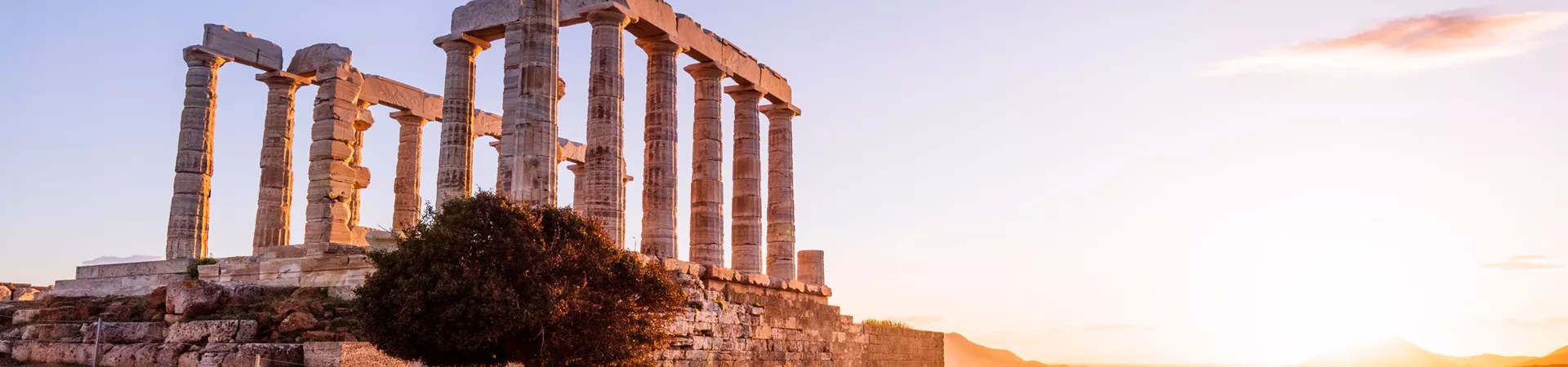 Sun setting over the Temple Of Zeus At Sounion in Greece