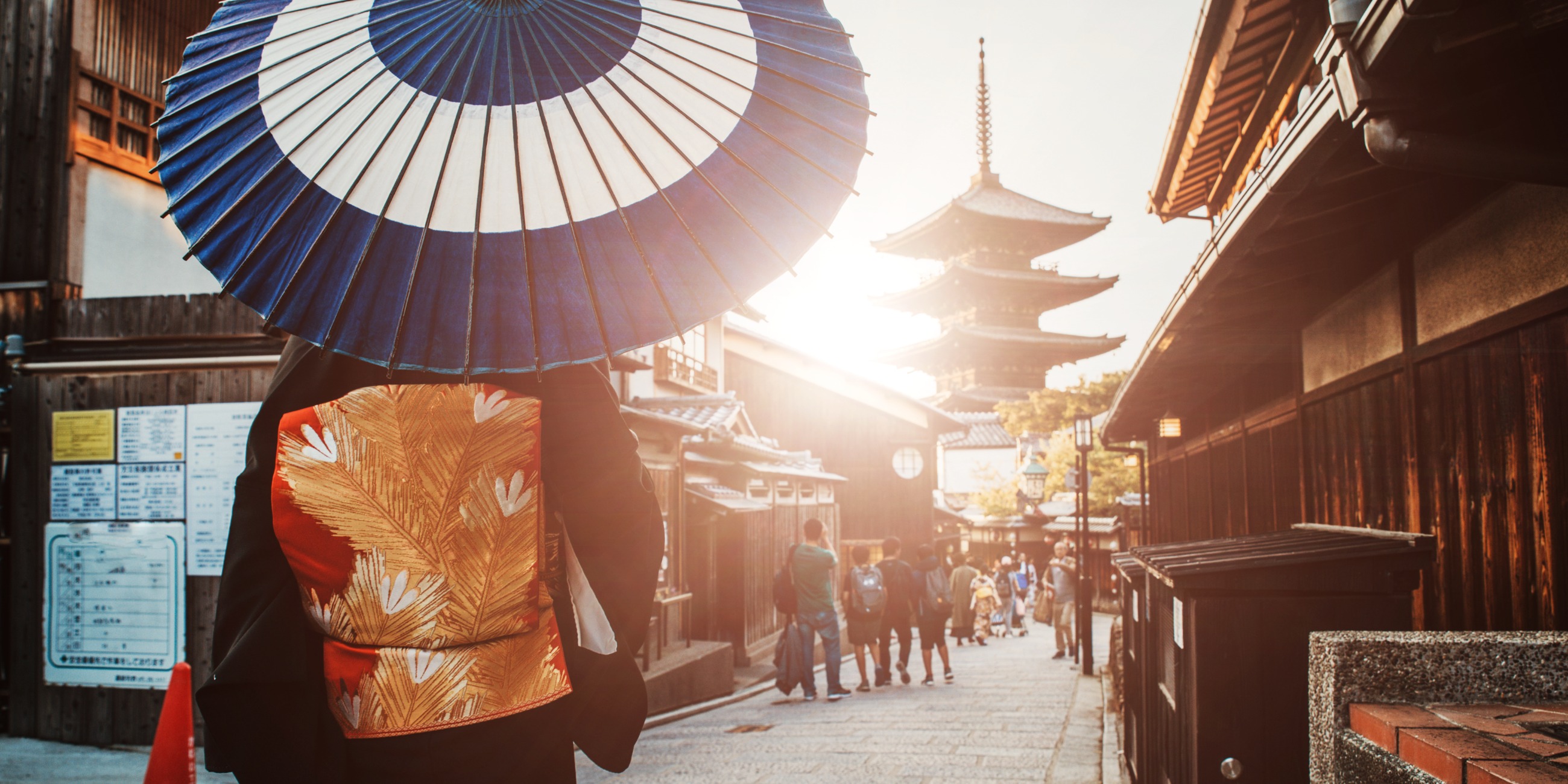 A person with umbrella walking through old traditional street in Tokyo, Japan