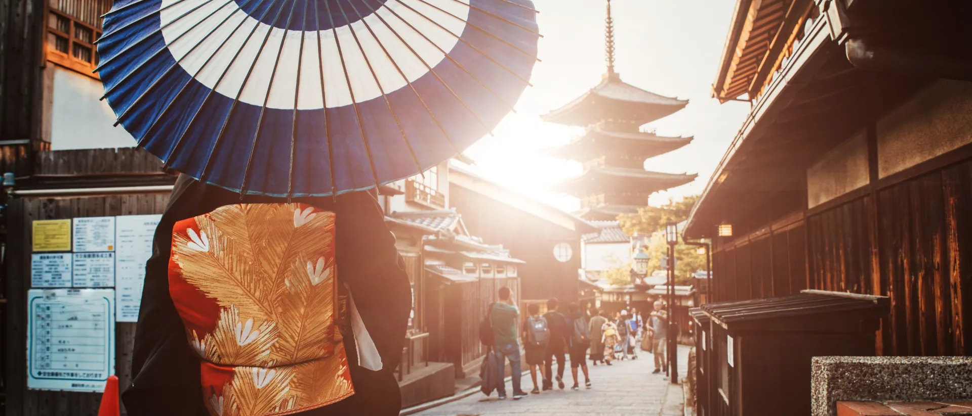 A person with umbrella walking through old traditional street in Tokyo, Japan