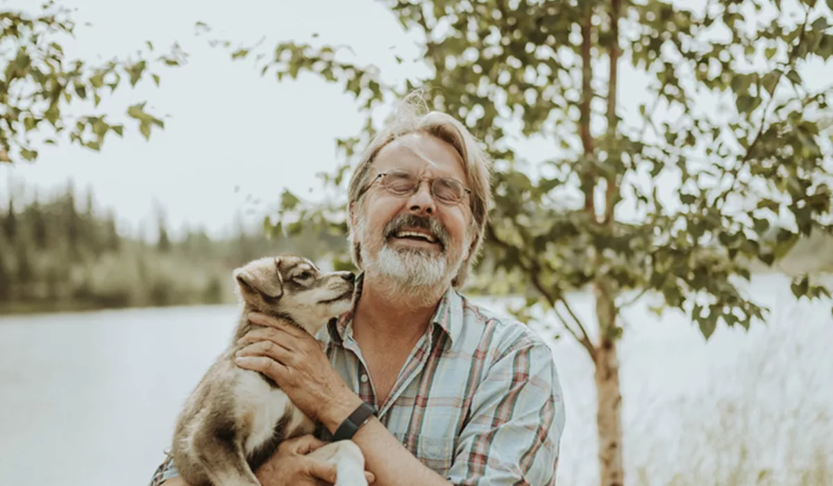  Dave Monson with a puppy at Trail Breaker Kennels in Fairbanks, Alaska 