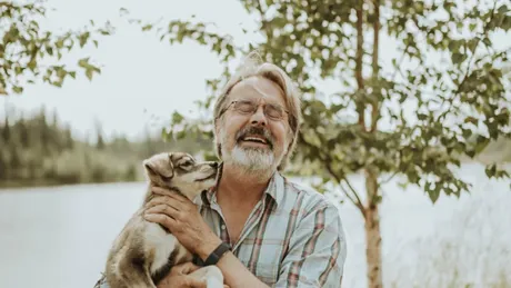 Dave Monson with a puppy at Trail Breaker Kennels in Fairbanks, Alaska