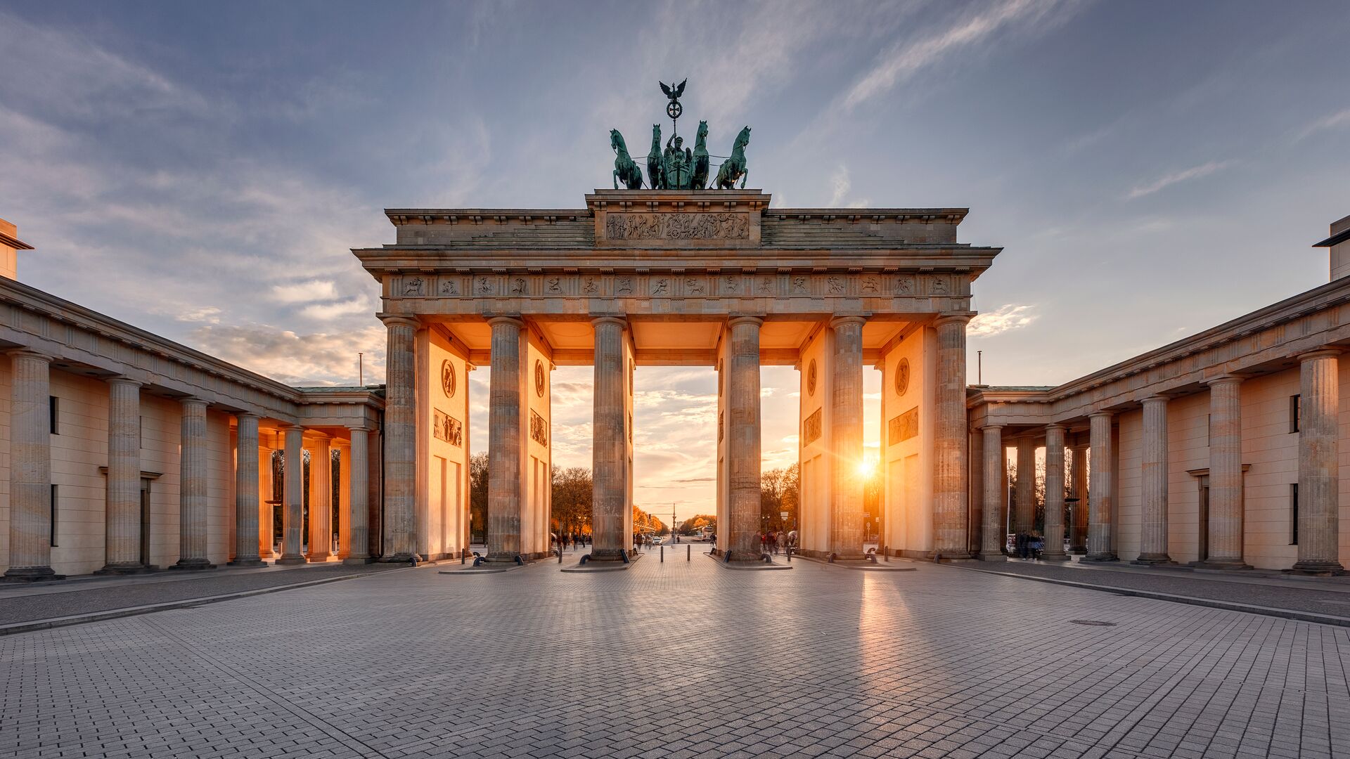 The Brandenburg Gate in Berlin with the sun setting behind it