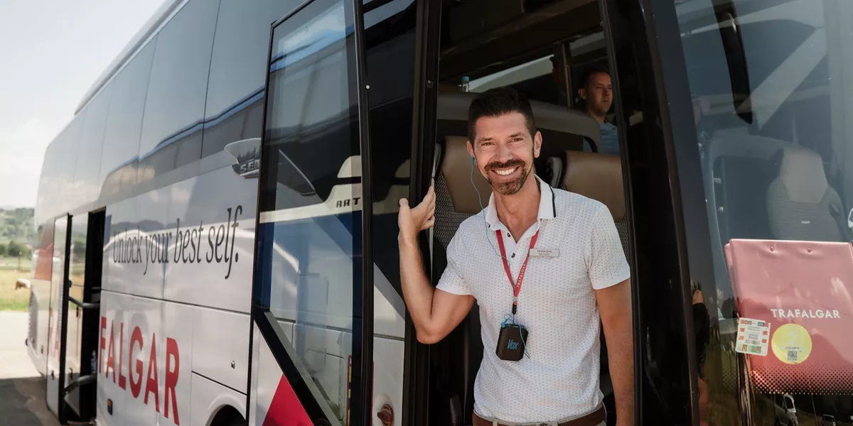 Travel Director standing in entrance to coach