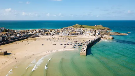 Aerial View Of St Ives A Wide Sandy Beach And Sheltered Harbour With Boats