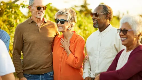 Happy group of tourists in Vineyard at sunset