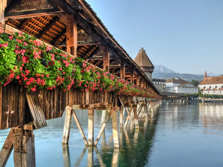 Bridge covered in flowers over water in Lucerne, Switzerland