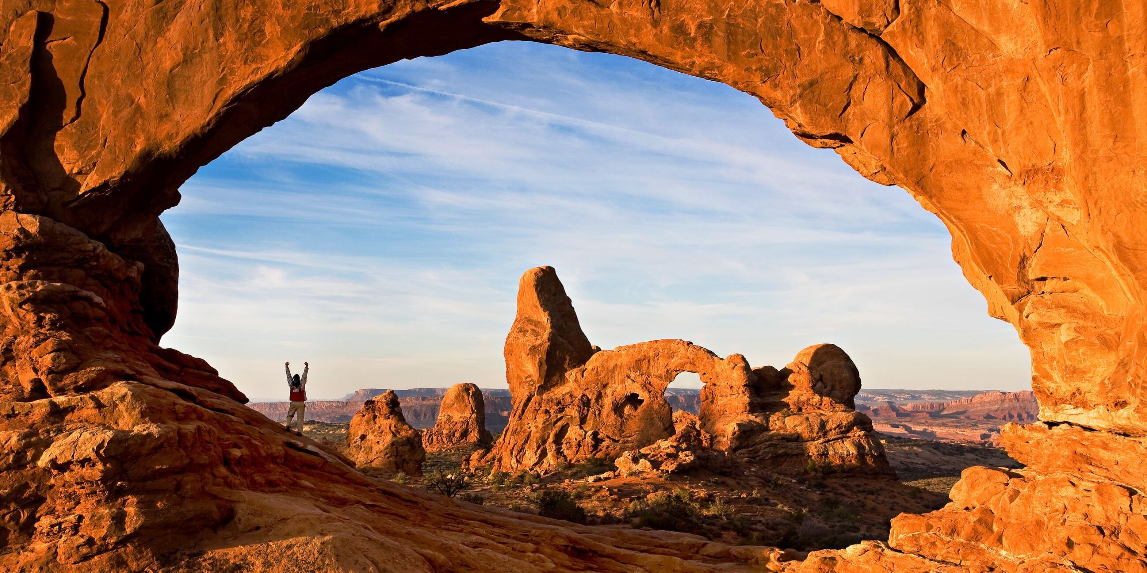 Hiker in North Window Arch in Utah, USA