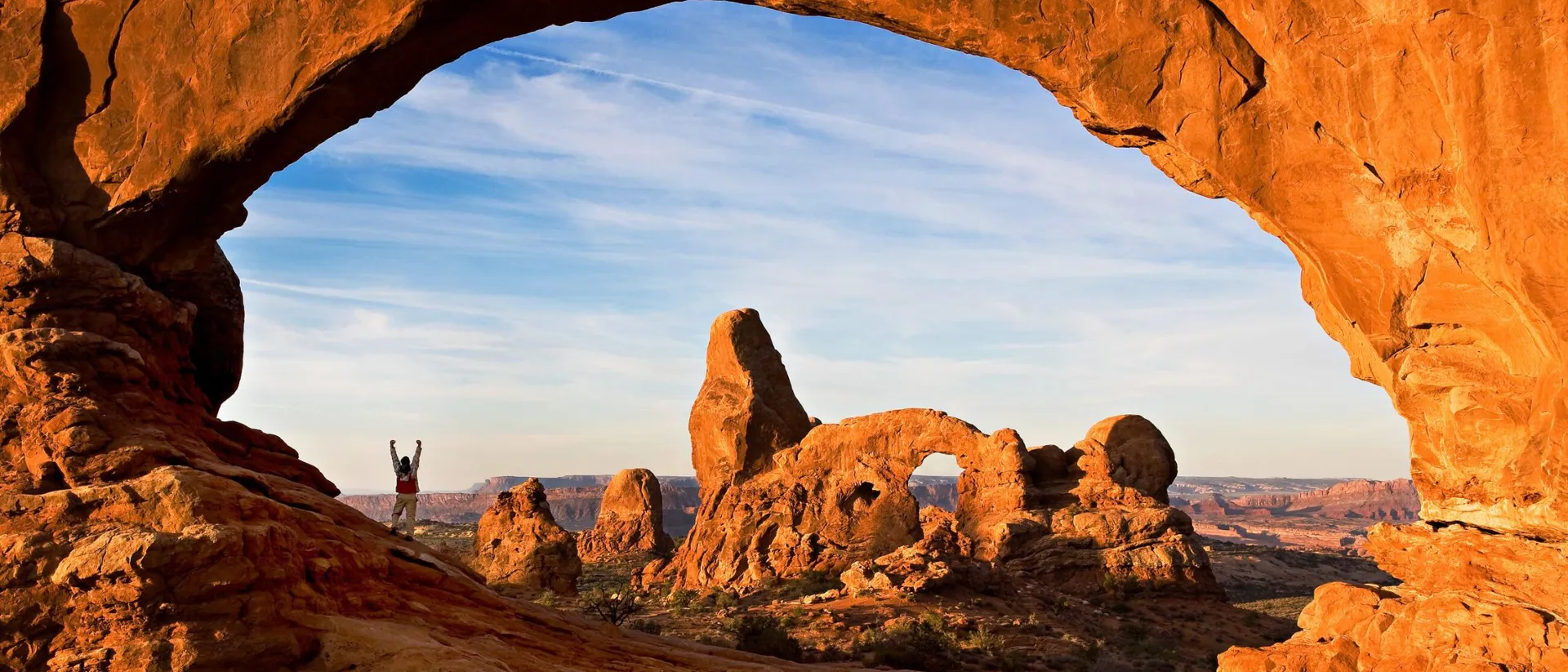 Hiker in North Window Arch in Utah, USA
