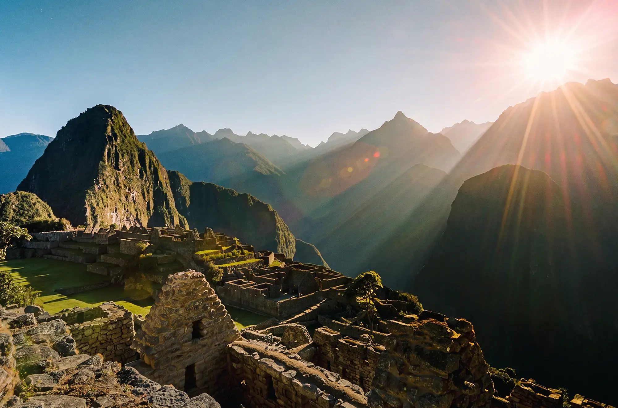 day-hero-sun-rising-over-the-mountains-at-machu-picchu-peru-545351380.webp