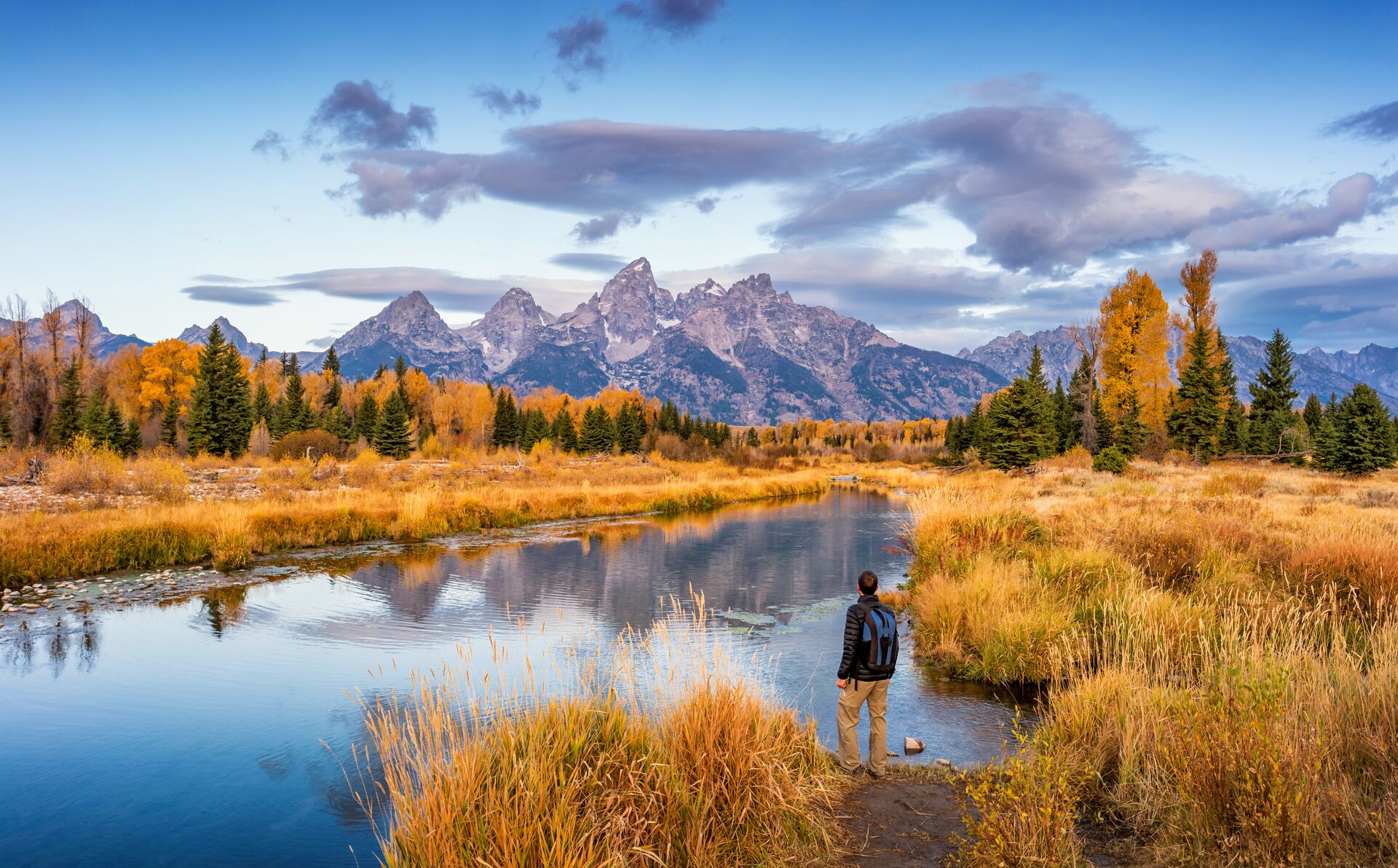 Hiker admiring the mountains in Grand Teton National Park in Wyoming, USA