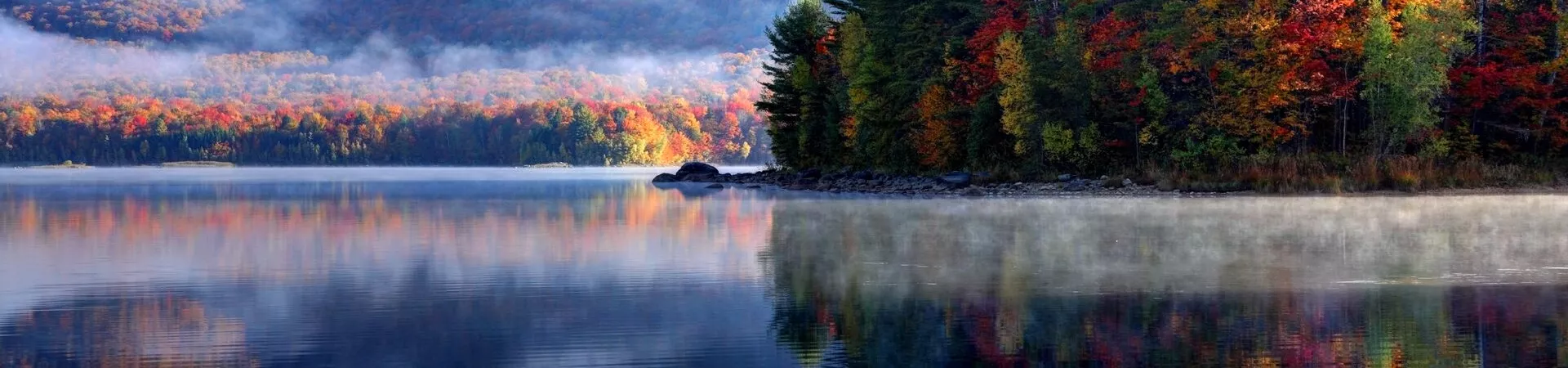 Autumnal leaves reflected in a lake during fall in USA