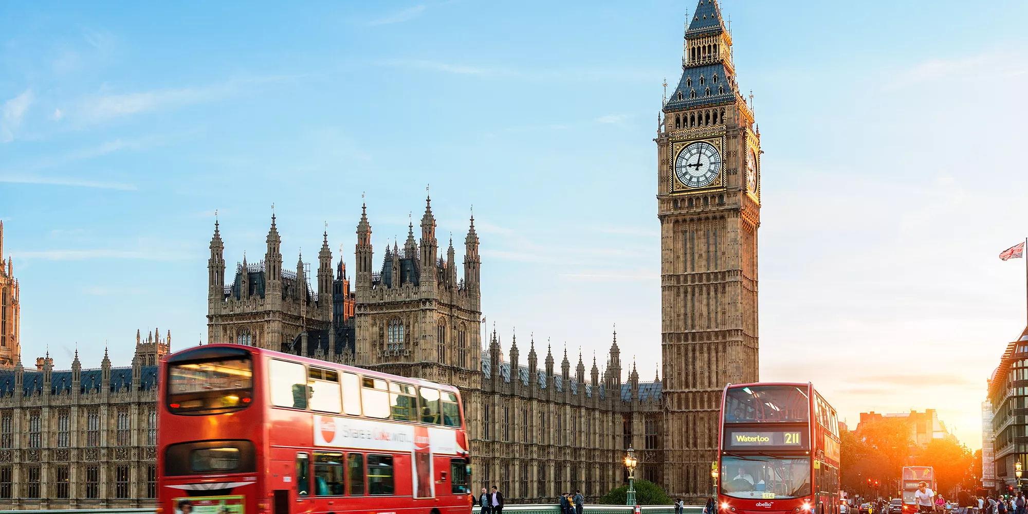 Red bus passing Big Ben in London