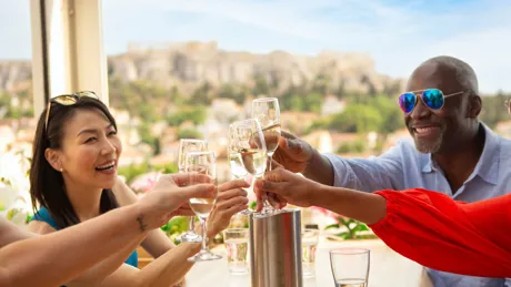 Tourists drinking wine on terrace in Athens