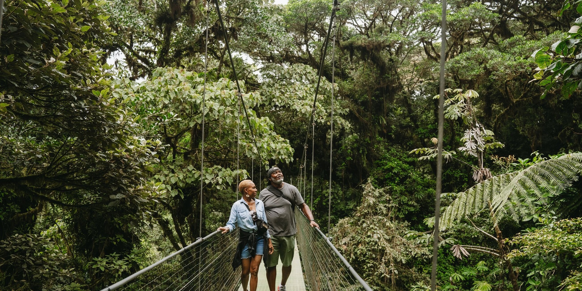 Cheryl and Al walking the sky walk amidst the greenery