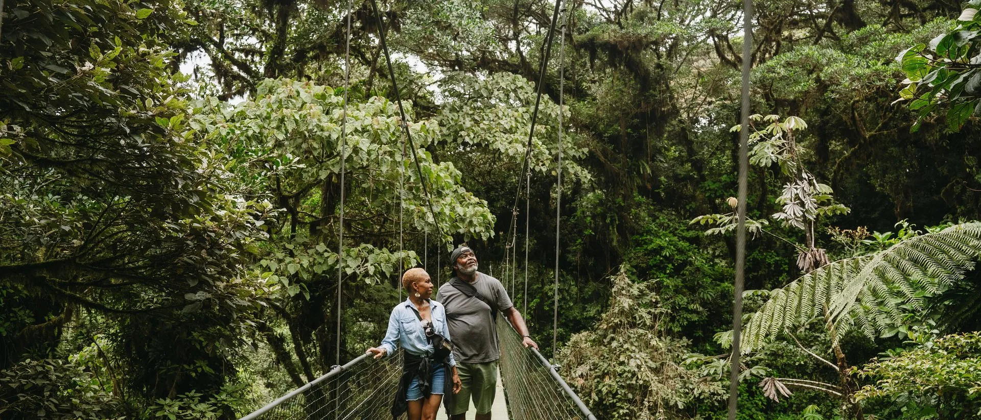 Cheryl and Al walking the sky walk amidst the greenery