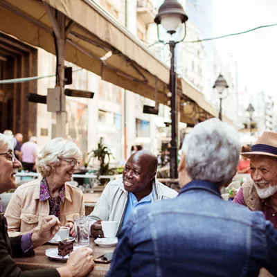 Older travellers taking a break at a cafe
