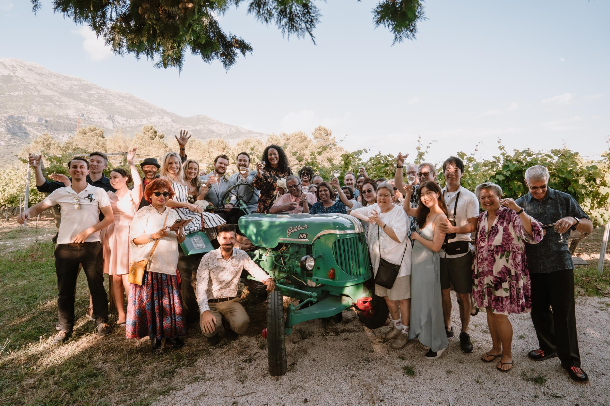 Group of travellers with green tractor in mountains