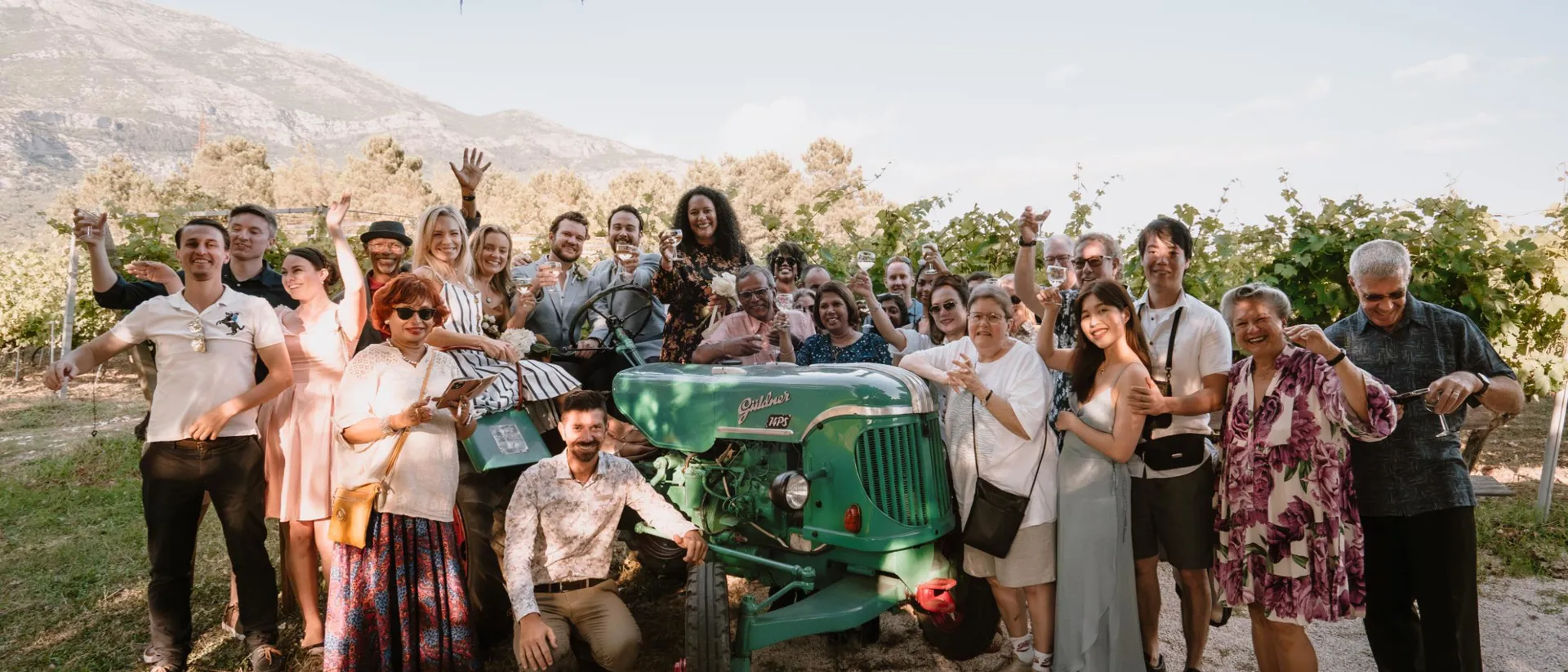 Group of travellers with green tractor in mountains