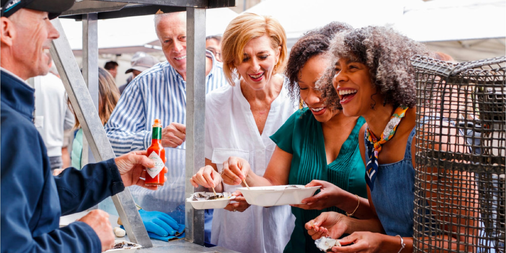 People tasting local delicacies at a market in Salamanca, Spain
