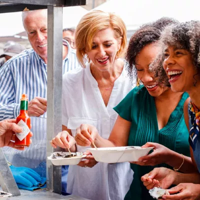 People tasting local delicacies at a market in Salamanca, Spain