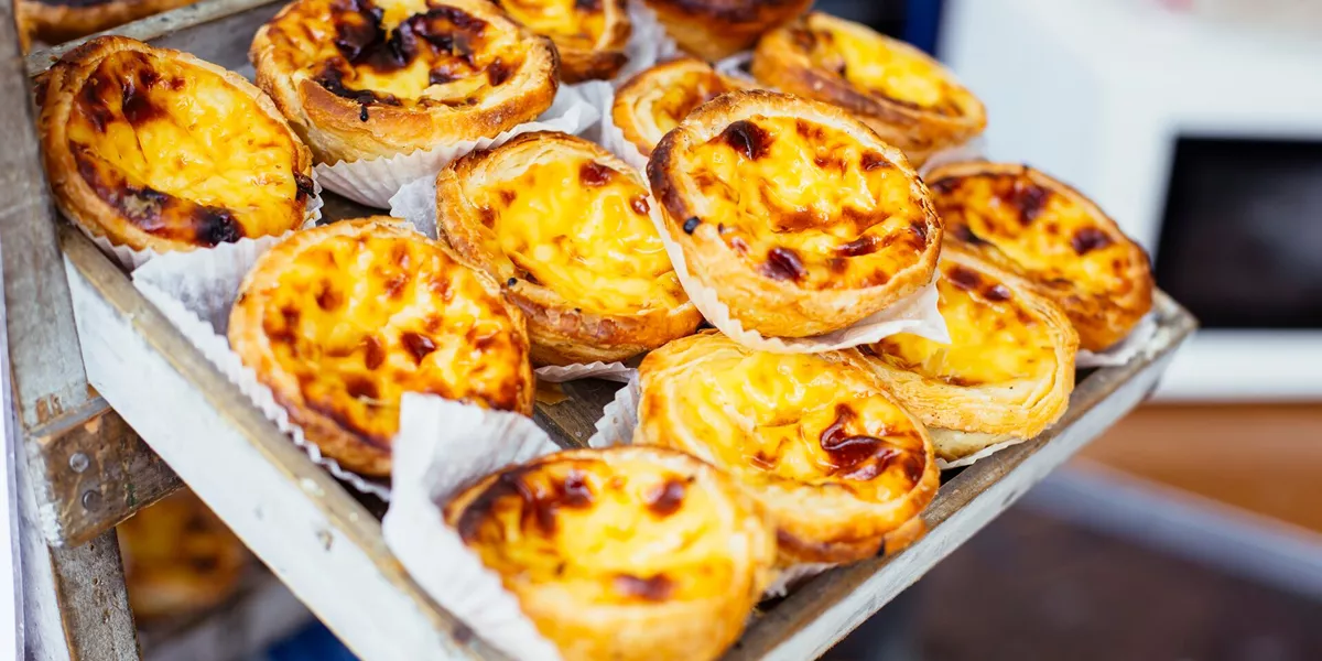 Traditional Portuguese pastry Pastel de Nata on a market stand