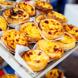 Traditional Portuguese pastry Pastel de Nata on a market stand