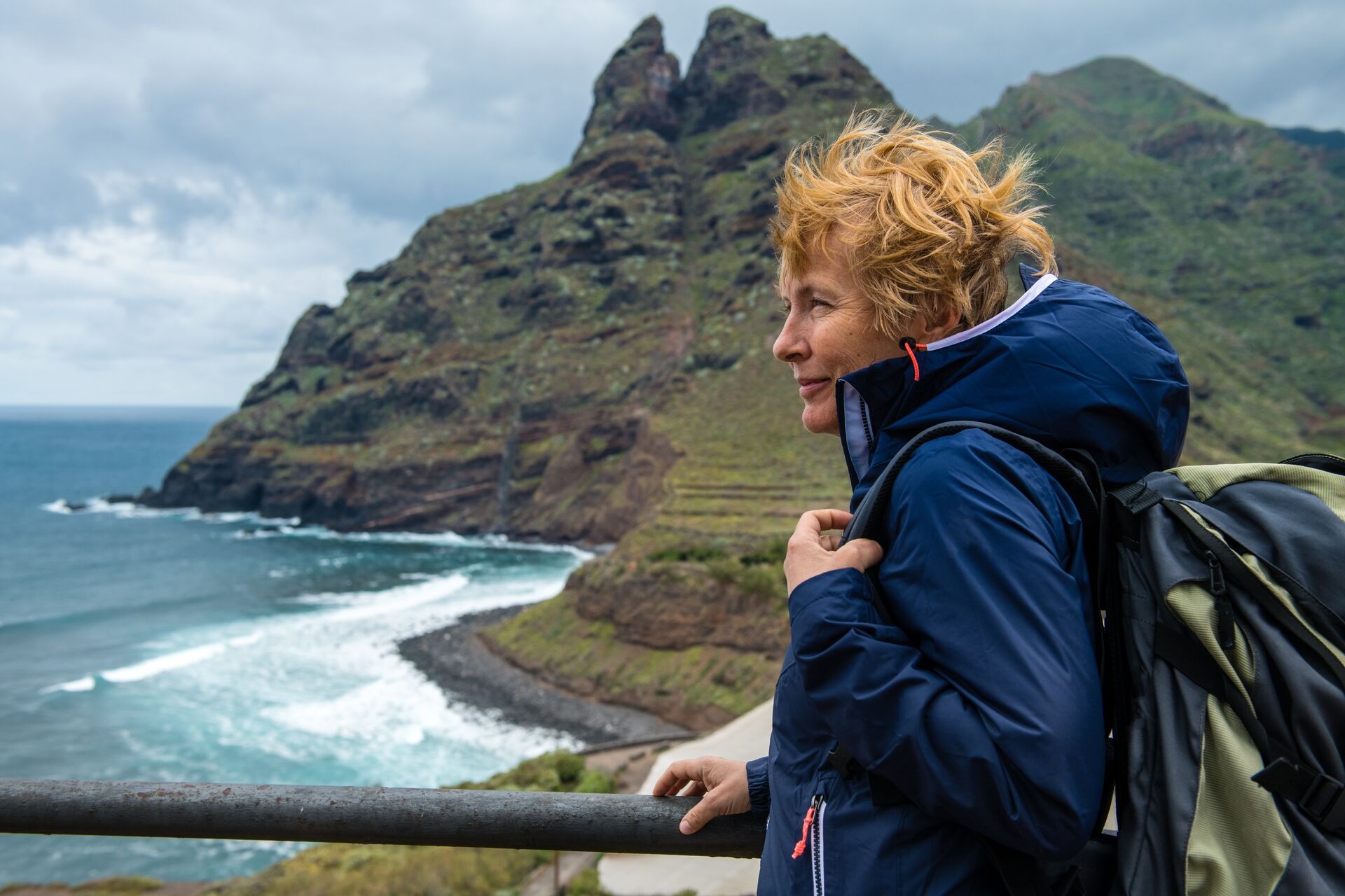 Woman exploring a beautiful island at windy day