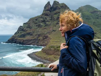 Woman exploring a beautiful island at windy day