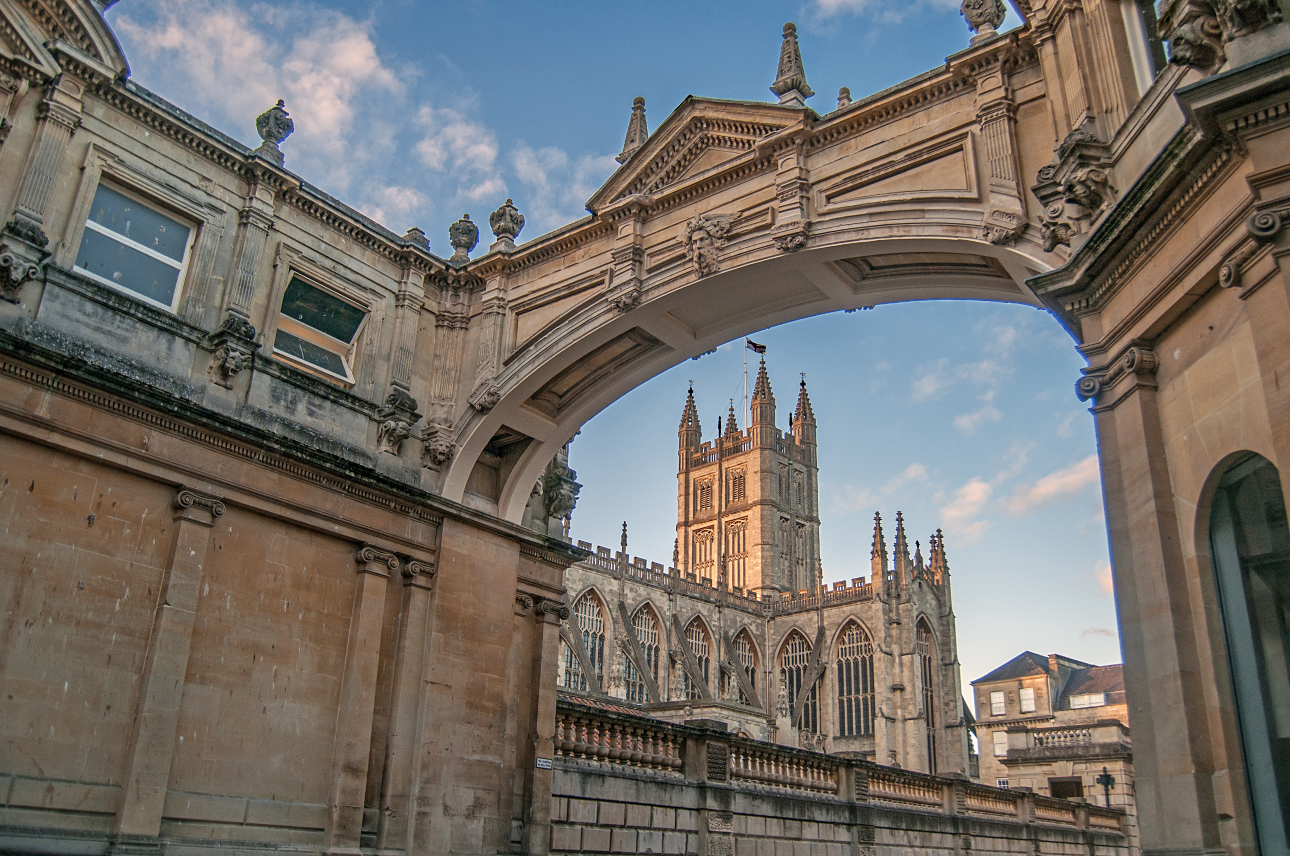day-hero-view-of-bath-abbey-through-an-arch-bath-england-1250540824.webp