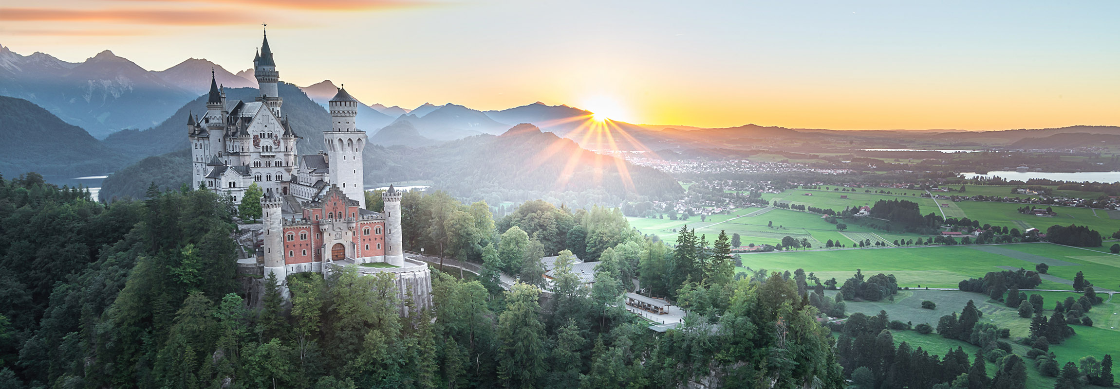 Neuschwanstein Castle on a hill in summer during sunrise in Germany 