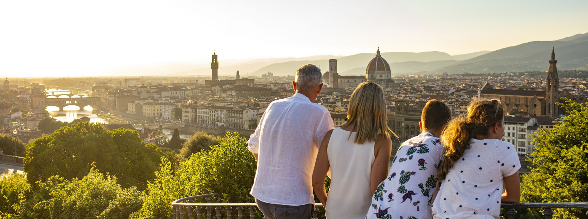 People looking at Italian Florence skyline with buildings at sunset