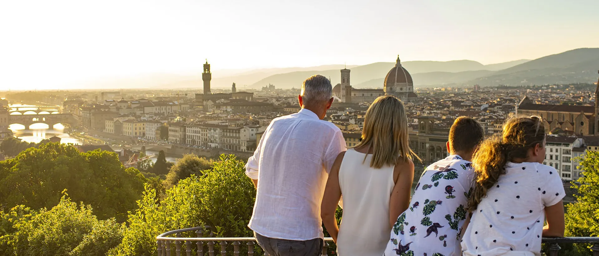 People looking at Italian Florence skyline with buildings at sunset