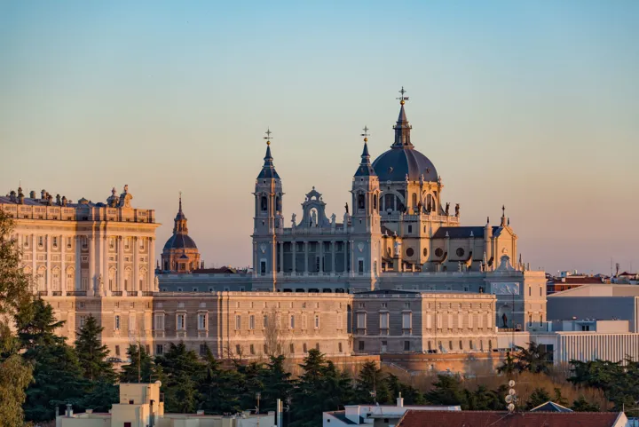 Soft hues of sunlight upon the Royal Palace and Cathedral in Madrid