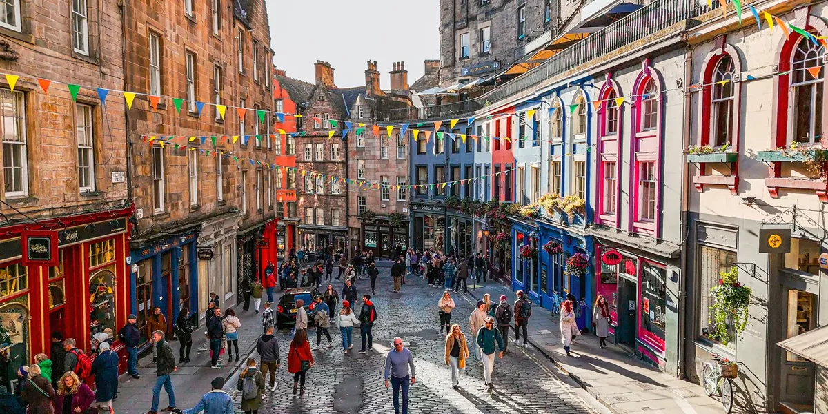 People shopping on Edinburgh's famous Victoria Street on a sunny day in Edinburgh, Scotland