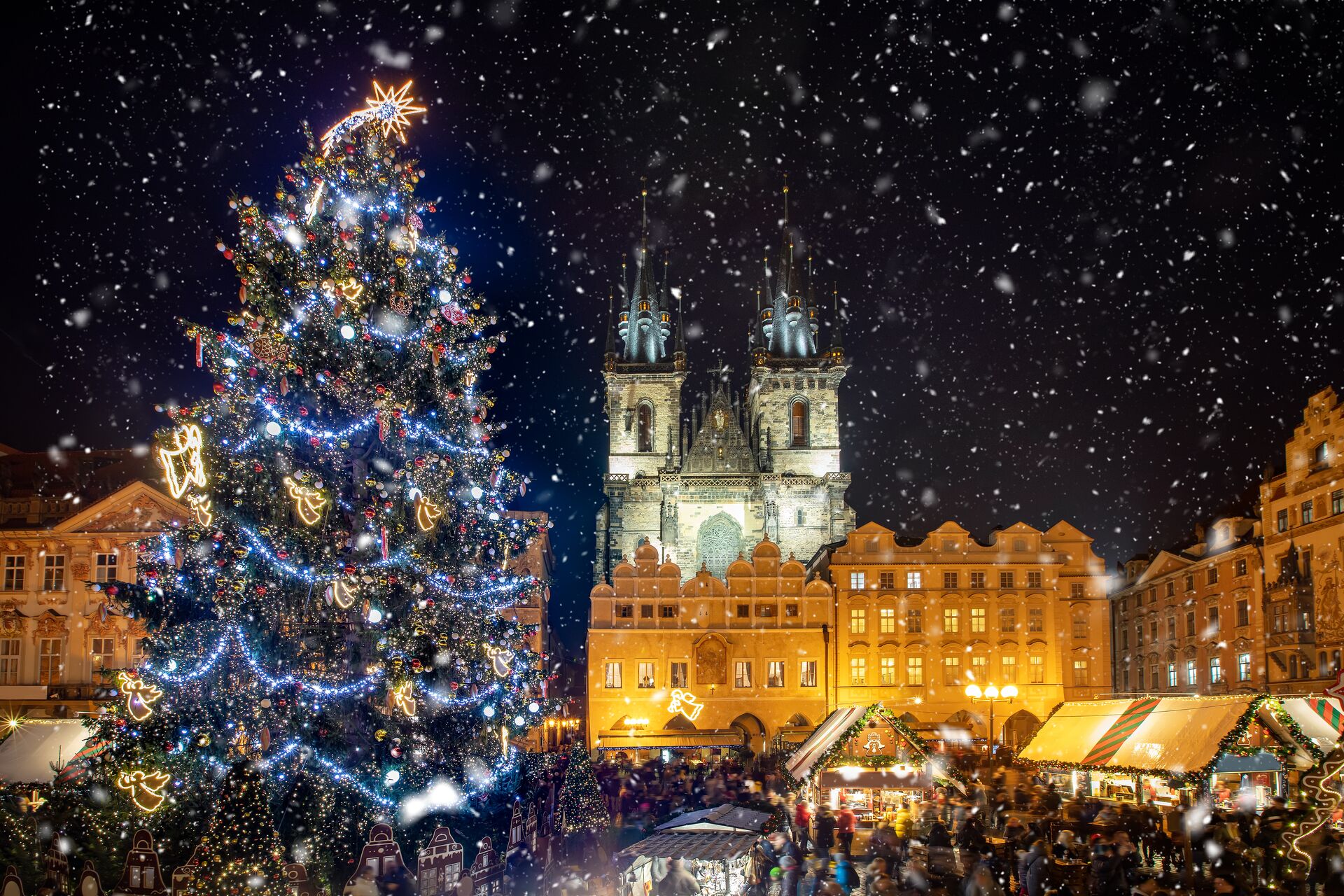 Christmas Tree and Tyn Church at night with the snow falling in Prague, Eastern Europe