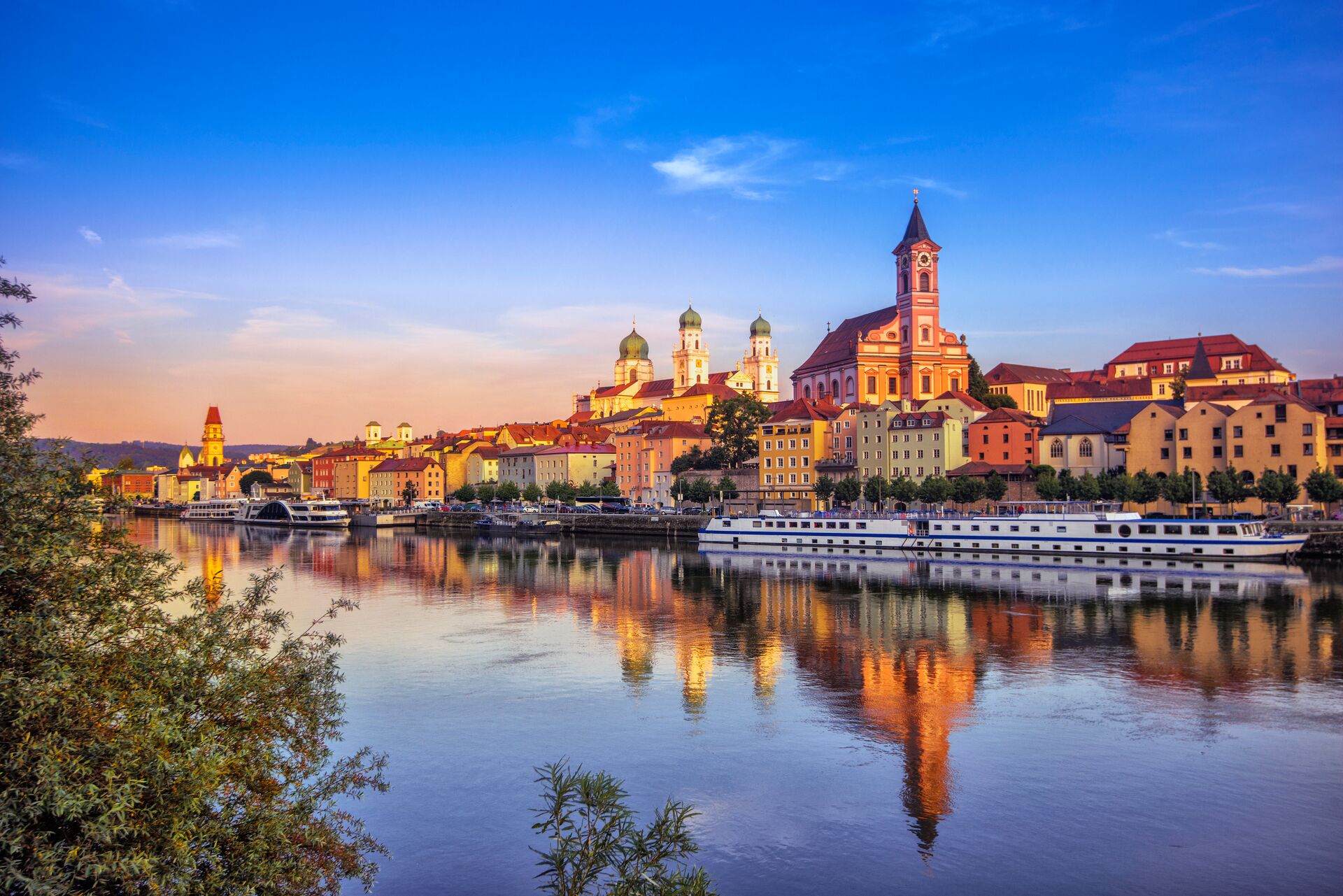 The waterfront and sightseeing boats in Passau in Germany at sunset
