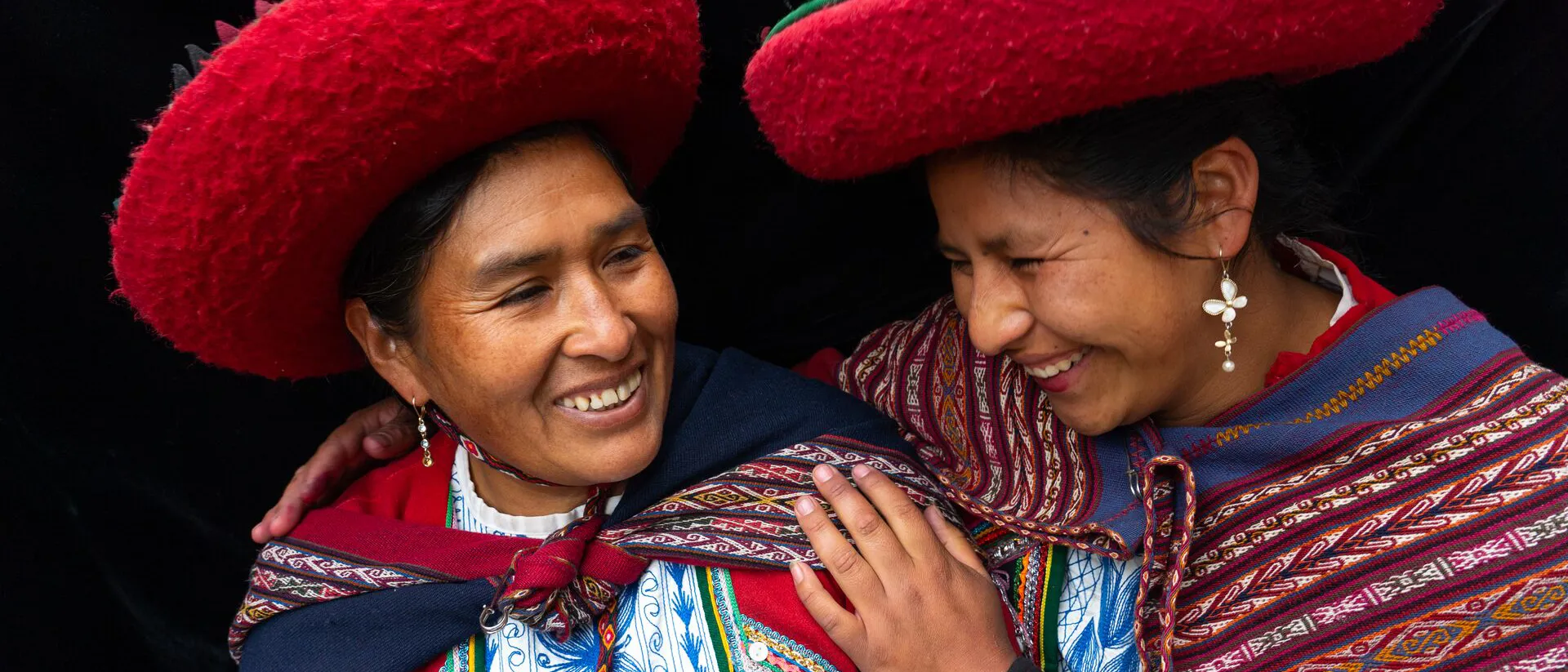 Two Women In Colourful Traditional Local Dress And Hats in Chinchero, Sacred Valley, Peru