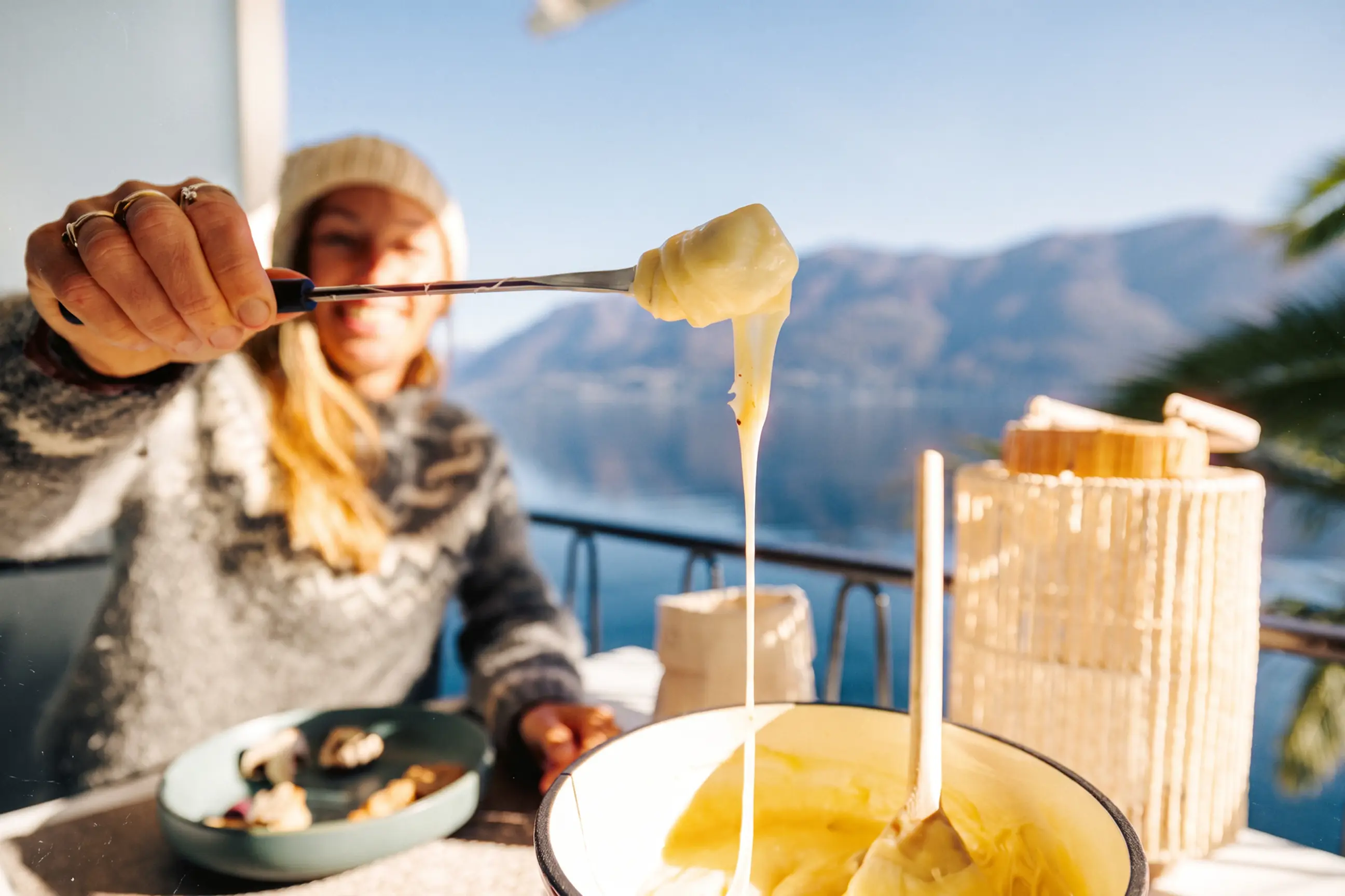 day-hero-cheese-fondue-by-the-lake-switzerland-2187645949.webp