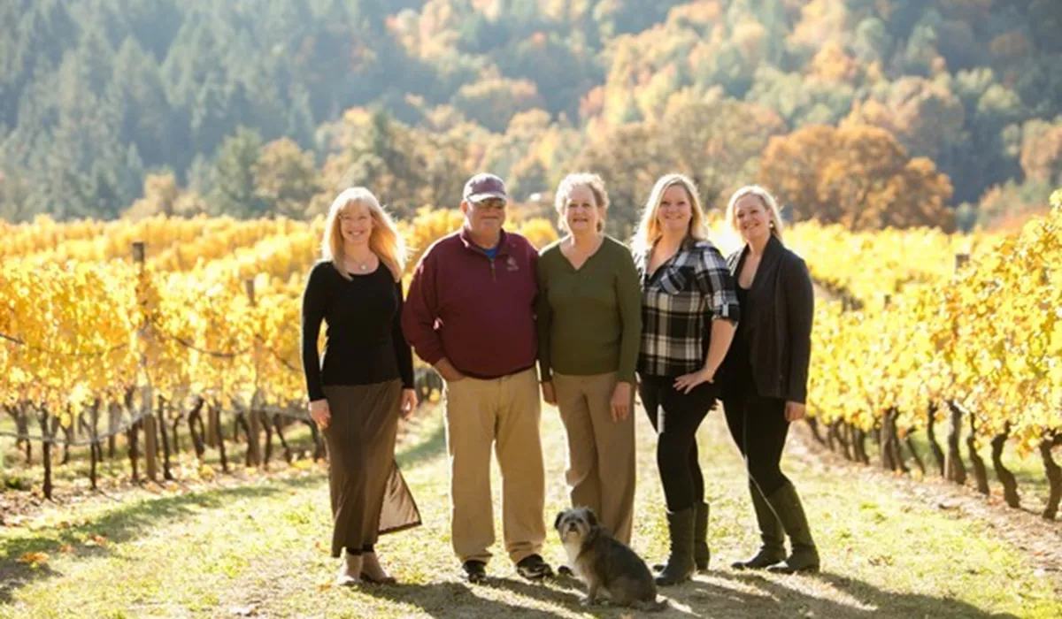 Kramer Family Standing On Road In The Middle Of Their Wiliamette Winery In Uregon, USA
