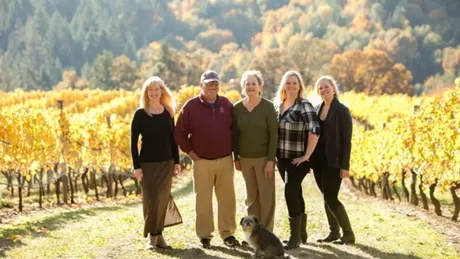 Kramer Family Standing On Road In The Middle Of Their Wiliamette Winery In Uregon, USA
