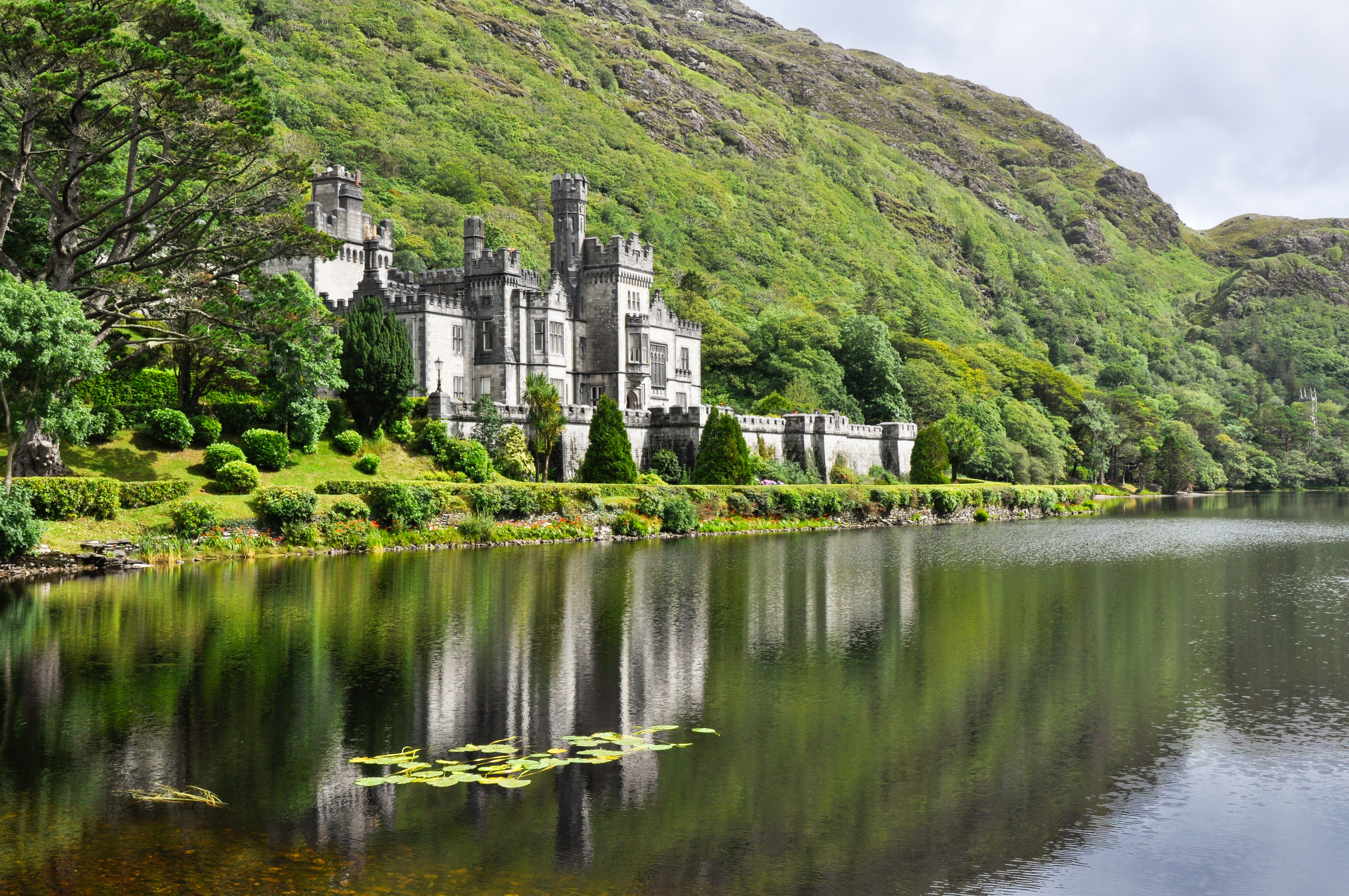 View From Water Of Kylemore Abbey Near Trees In Ireland 157986678