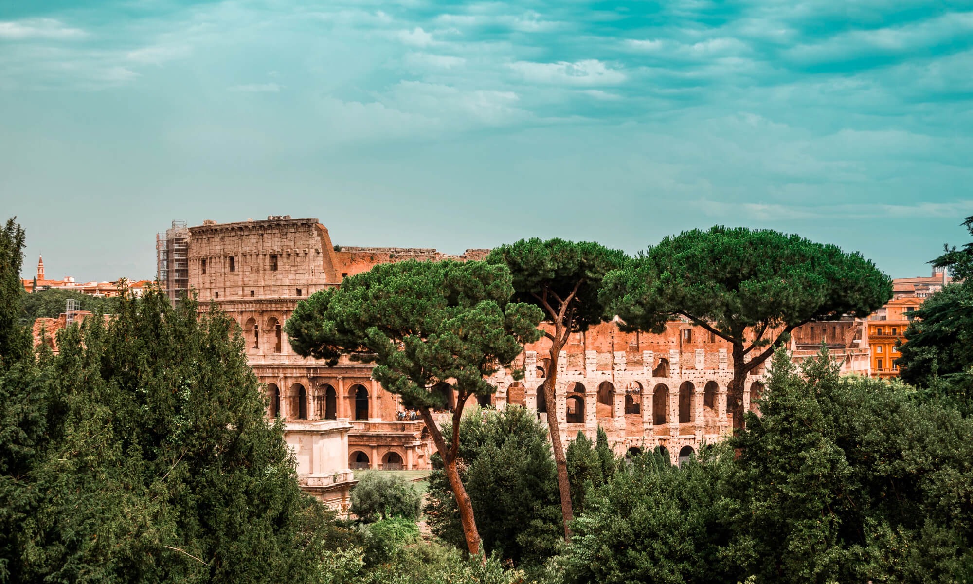View on collosseum behind the trees in Italy, Rome