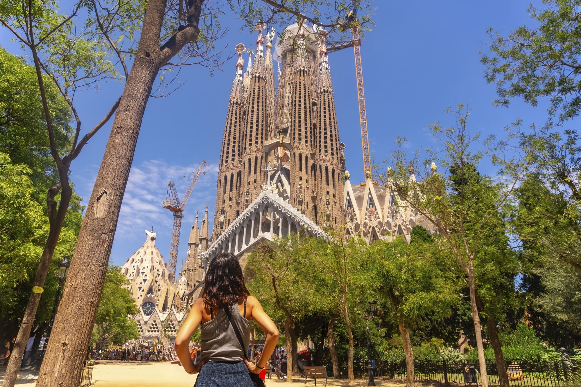Woman standing in front of Basílica de la Sagrada Família, Spain